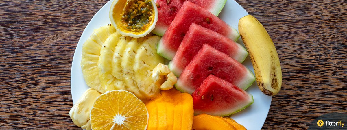 A plate full of fruits - mango, pineapple, banana, watermelon etc