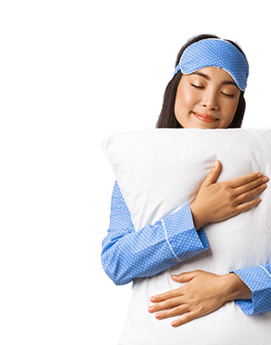 Smiling women holding a pillow